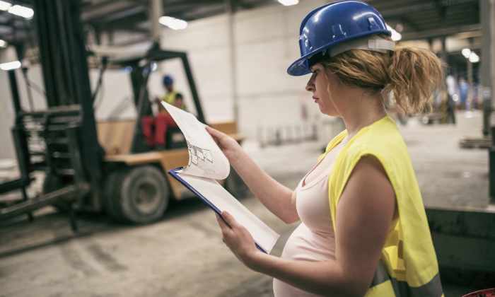 Pregnant worker in a hard hat